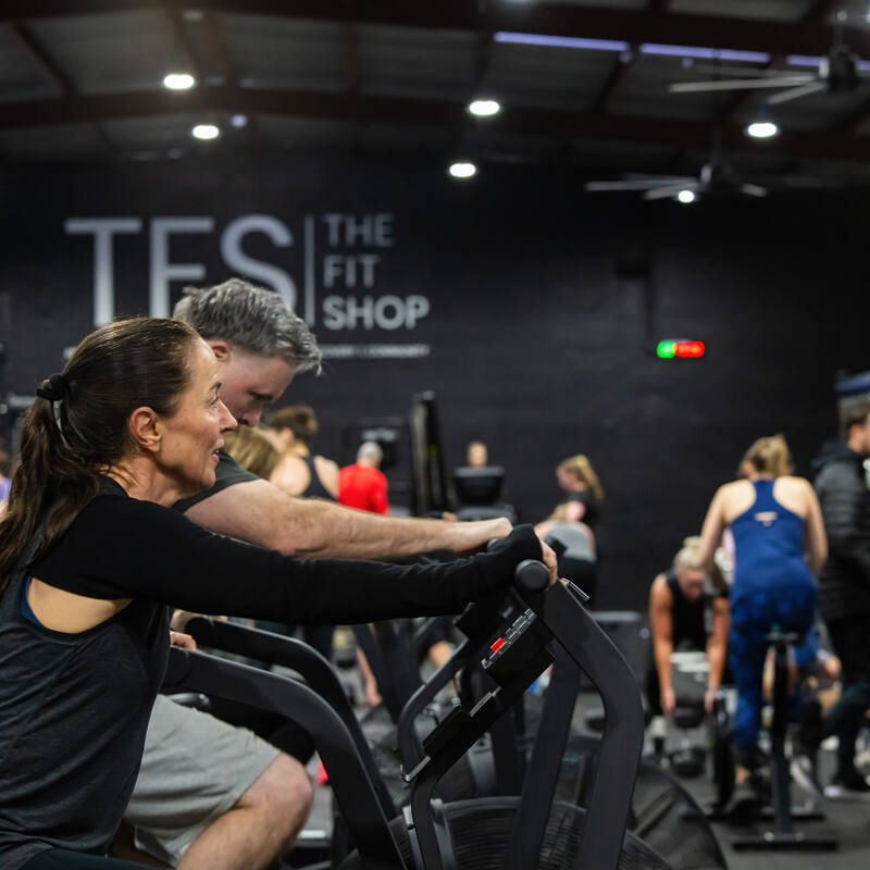 A coach encouraging a member on the bike